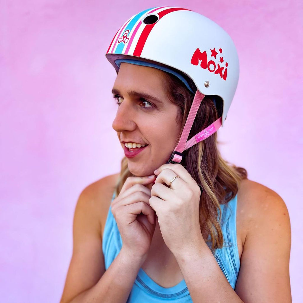 Skater putting on Stripey helmet.