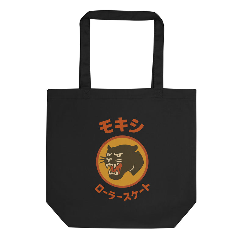 Black Moxi canvas tote bag featuring a bold retro-style panther graphic in an orange circle with Japanese katakana text above and below translating to “Moxi Roller Skates.” Durable cotton material with sturdy shoulder straps, ideal for everyday use.