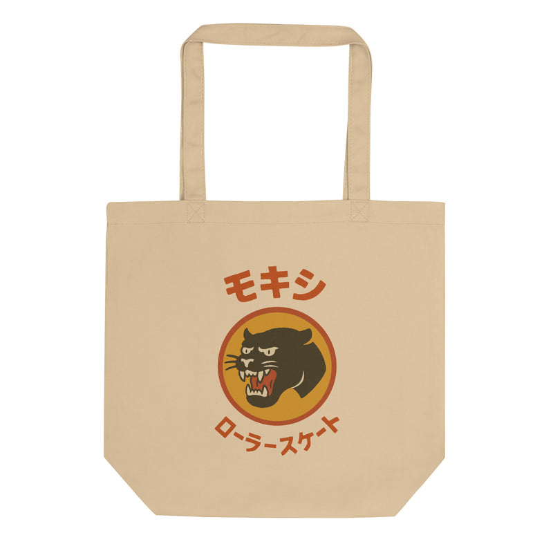 Beige Moxi canvas tote bag featuring a bold retro-style panther graphic in an orange circle with Japanese katakana text above and below translating to “Moxi Roller Skates.” Durable cotton material with sturdy shoulder straps, ideal for everyday use.