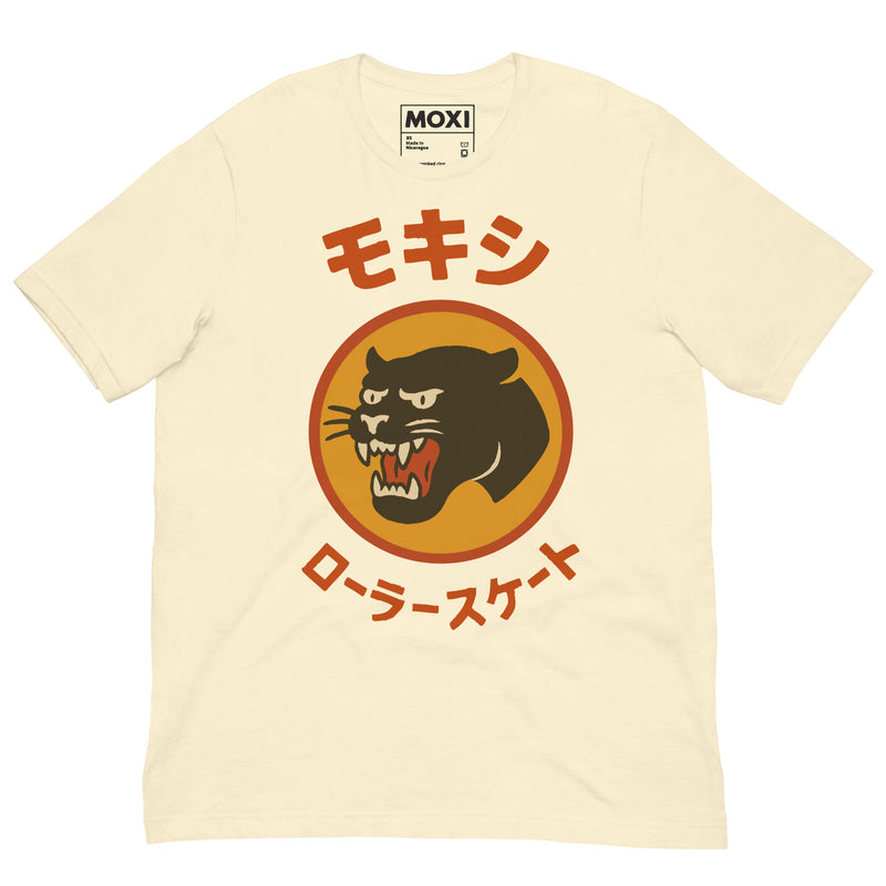 Cream Moxi unisex T-shirt featuring a bold black panther logo in an orange circle with red Japanese katakana text above and below, translating to “Moxi Roller Skates.” Soft cotton fabric with a classic crew neck fit.