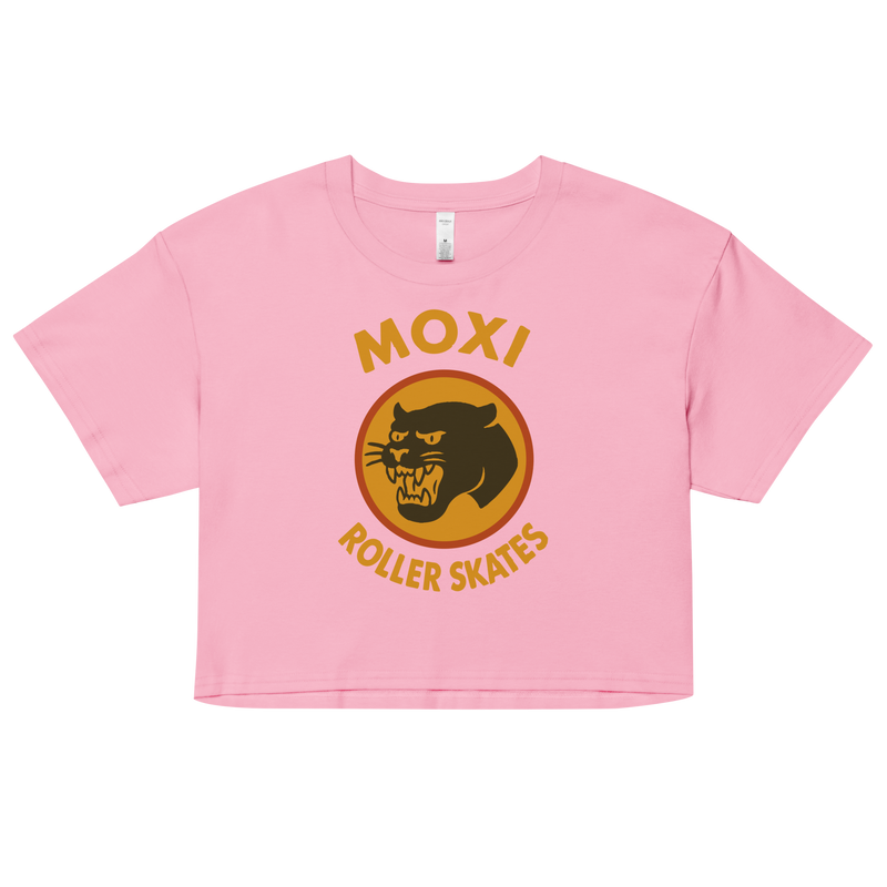 Pink Moxi crop top with short sleeves, featuring a bold vintage-style graphic of a yellow and orange panther logo and “MOXI Roller Skates” text on the front.