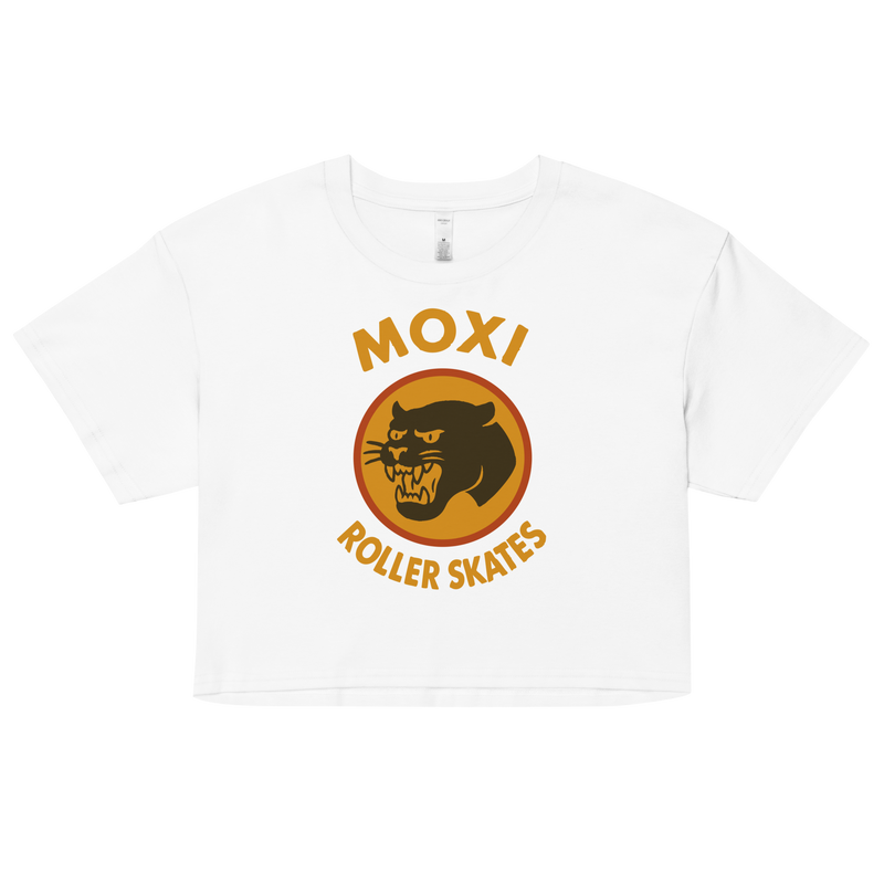 White Moxi crop top with short sleeves, featuring a bold vintage-style graphic of a yellow and orange panther logo and “MOXI Roller Skates” text on the front.